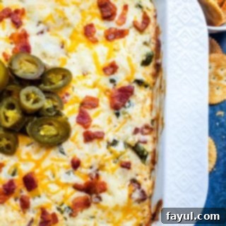 Loaded Bacon Jalapeno Burst 6 Overhead shot of jalapeno popper dip in white baking dish with crackers on side.