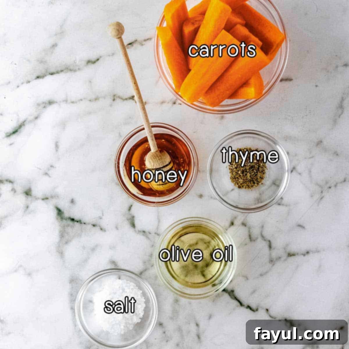 Overhead shot of ingredients - carrots, honey, thyme, olive oil, and salt.