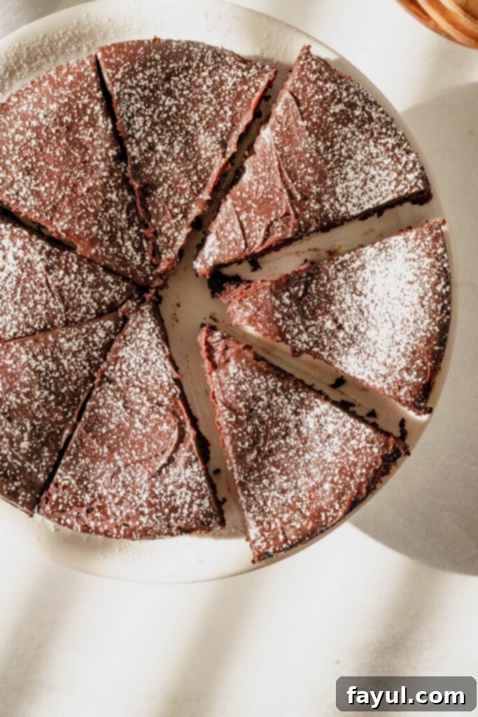 full flourless chocolate cake on a platter