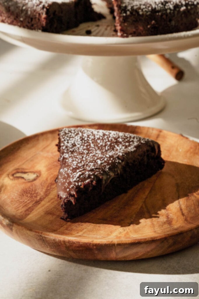 applying ganache to flourless chocolate cake