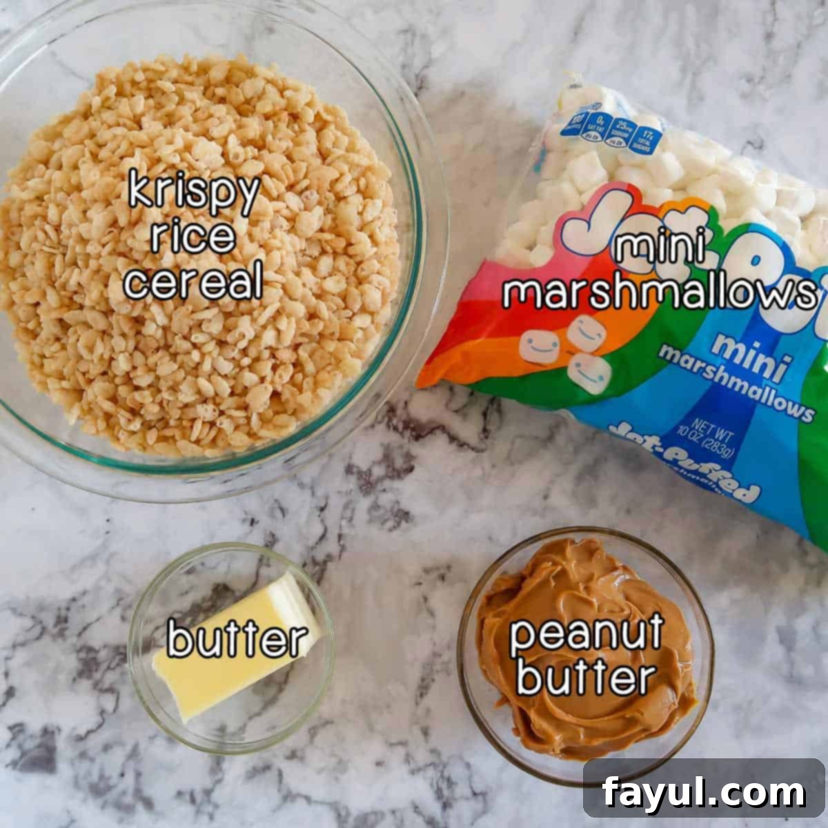 Overhead shot of ingredients - Krispy rice cereal, mini marshmallows, butter, and peanut butter, laid out on a clean surface.