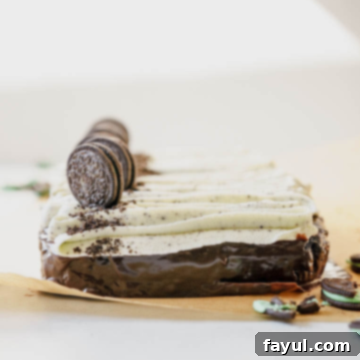 Grasshopper sheet cake with a slice removed