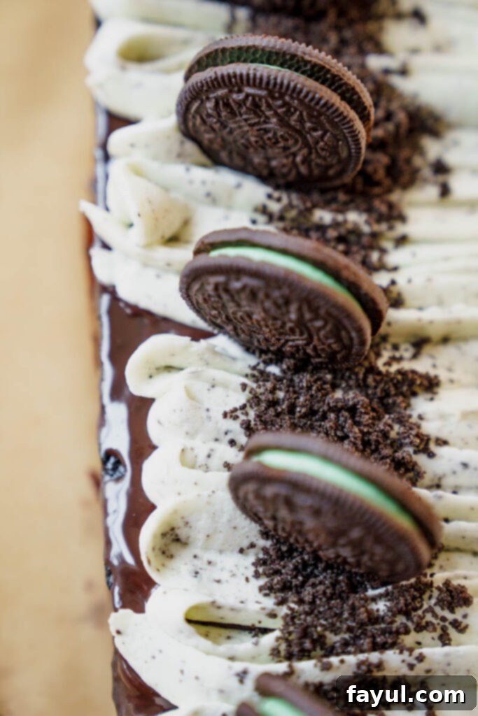 A smooth, dark chocolate ganache being poured over a cooled cake.