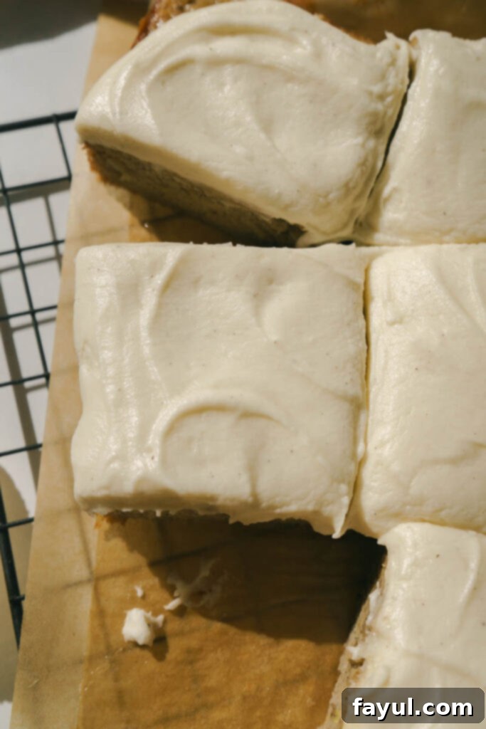 A generous slice of banana snack cake with thick cream cheese frosting