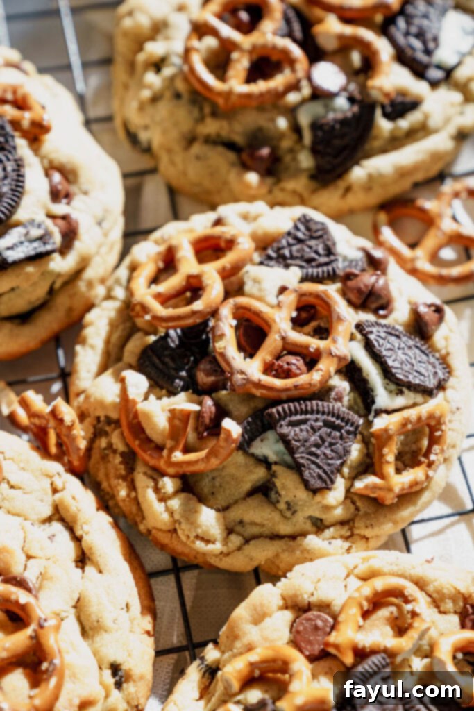 Peanut Butter Oreo Pretzel Cookie being lifted from a cooling rack