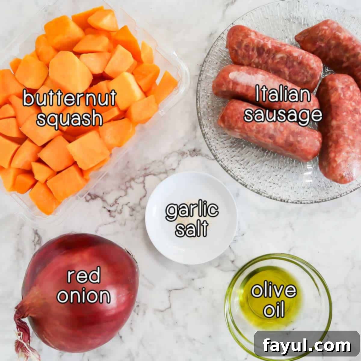 Overhead shot of ingredients - butternut squash, Italian sausage, red onion, garlic salt, and olive oil.
