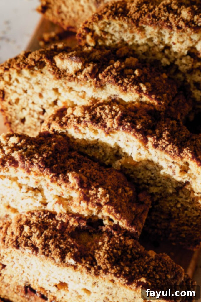 Close-up of a loaf of Nutella banana bread with a rich, golden brown crust and crumb topping.