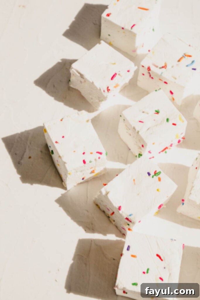A stack of homemade funfetti marshmallows on a plate, ready to be enjoyed or used in desserts.