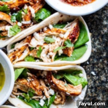Overhead shot of tacos on a dark marble counter.