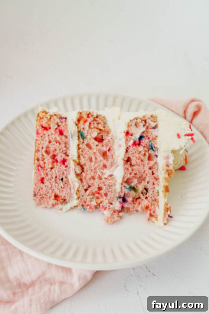 Strawberry Funfetti Cake with a slice cut out