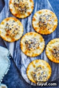 Everything Bagel Cheese Ball Bites arranged on a blue marble cutting board, ready to serve.