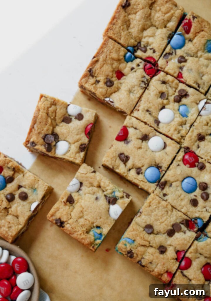 Close-up of baked Firework Blondies, showcasing the chewy texture and melted M&M's.