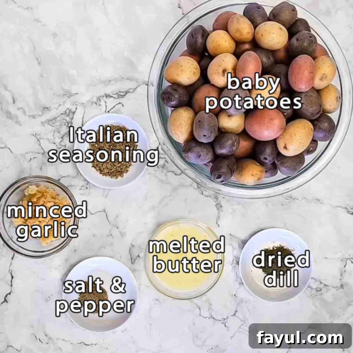 Overhead shot of ingredients - baby potatoes, Italian seasoning, minced garlic, melted butter, dried dill, salt, and pepper.