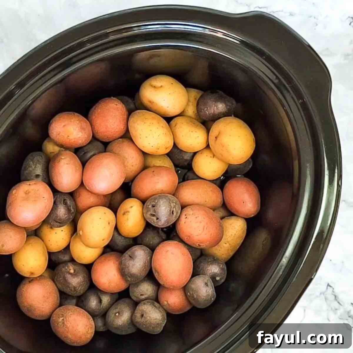 Overhead view of process shot 1 - place potatoes in slow cooker.