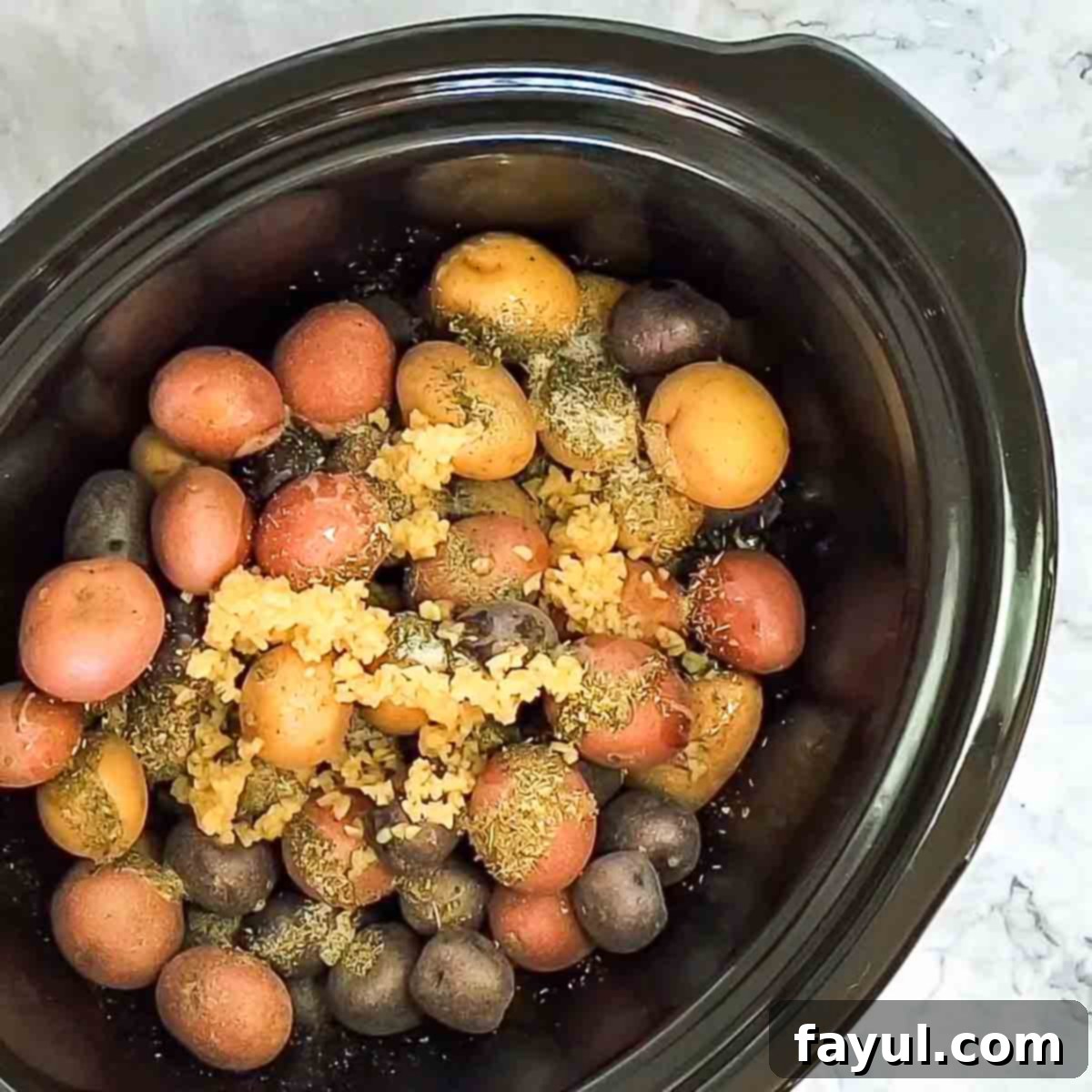 Overhead view of process shot 2 - adding remaining ingredients to the potatoes.