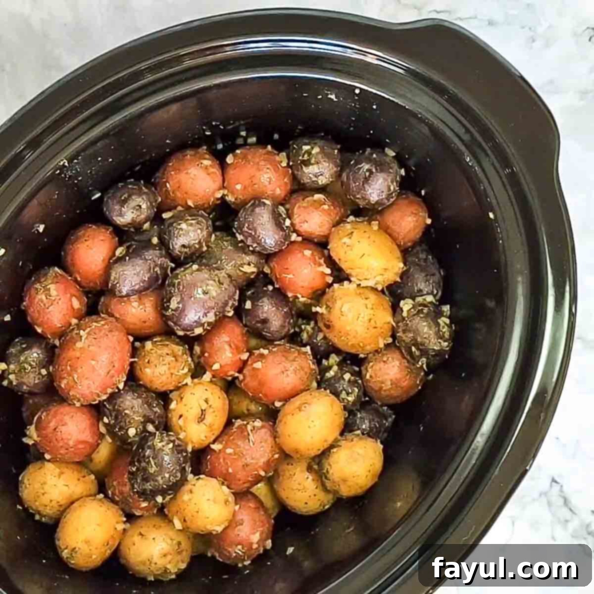 Overhead view of process shot 3 - toss the potatoes to coat them with the seasonings and butter.