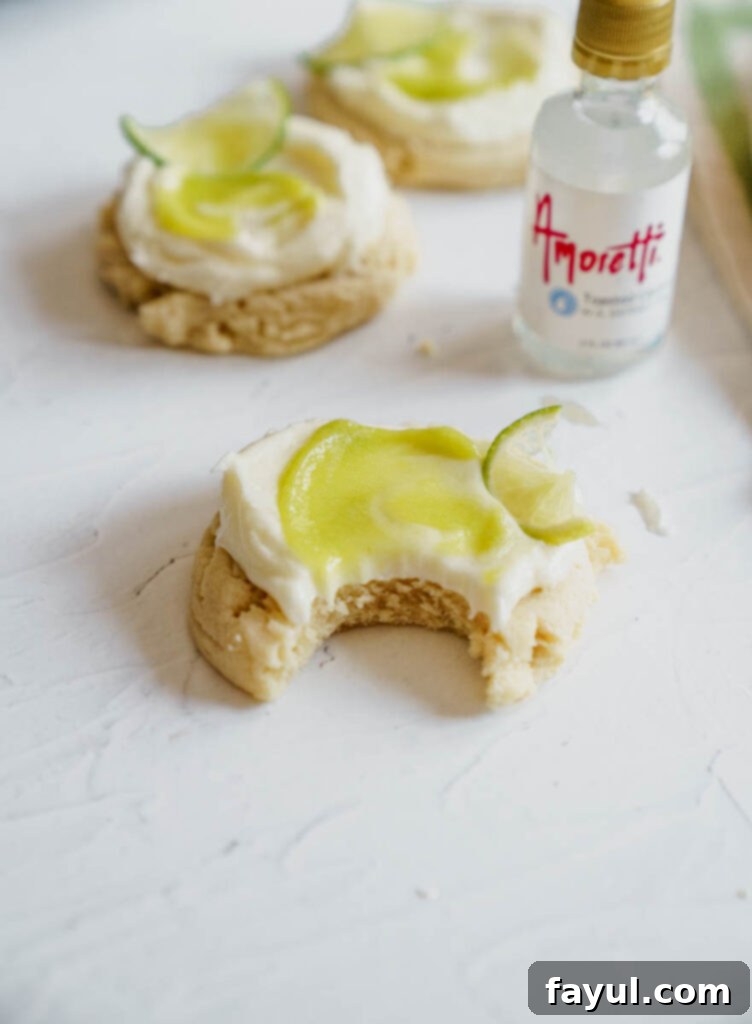 Stack of Frosted Coconut Lime Sugar Cookies with fresh lime