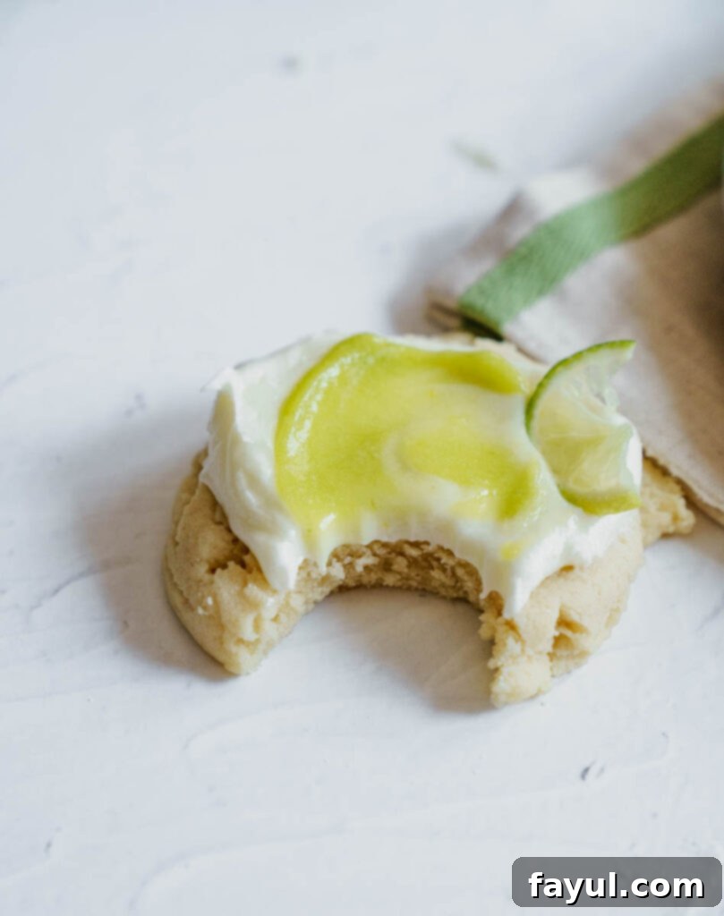 Frosted cookie with lime curd swirl on a plate