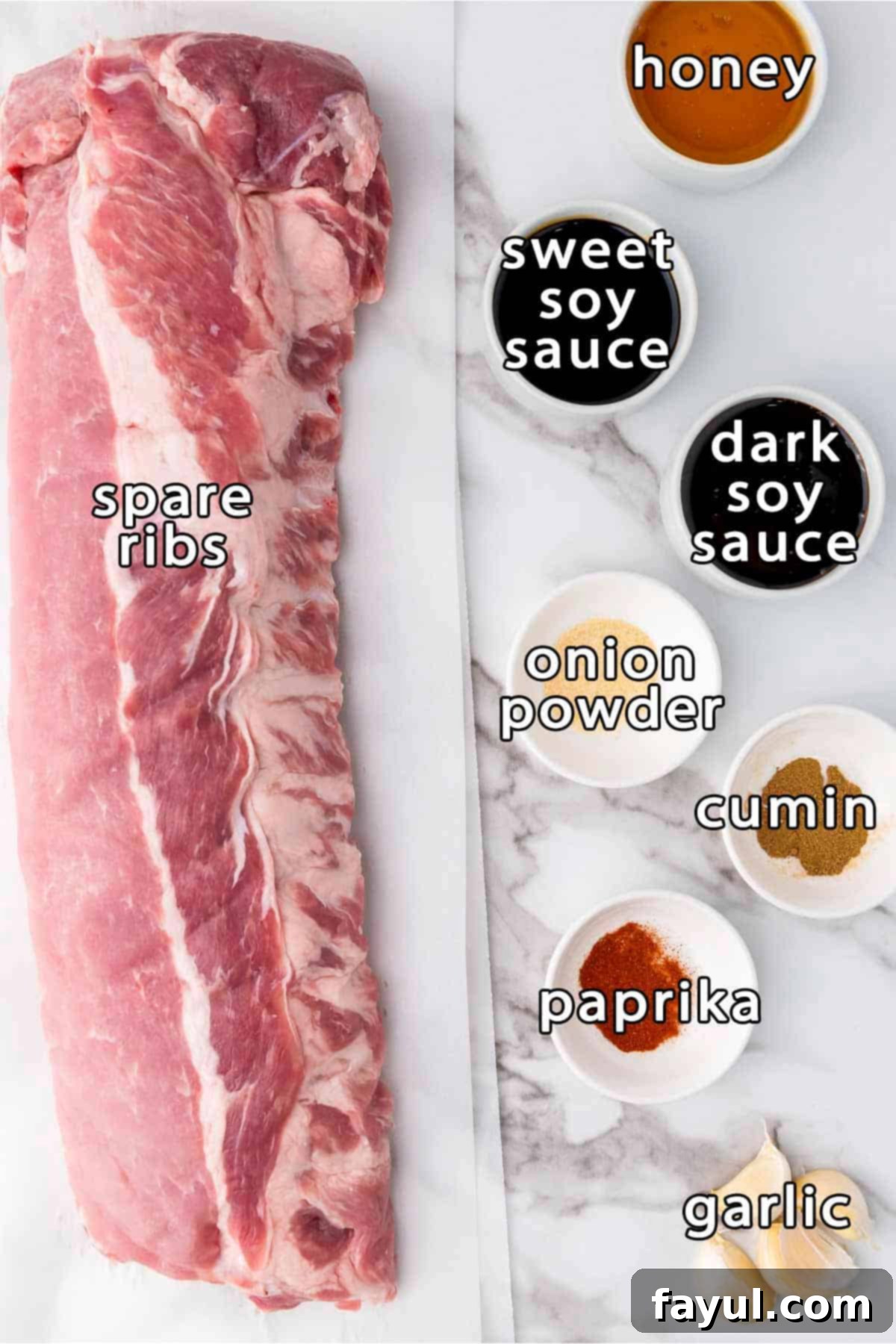 Overhead shot of ingredients - spare ribs, honey, sweet soy sauce, dark soy sauce, onion powder, cumin, paprika, and garlic cloves arranged on a cutting board.