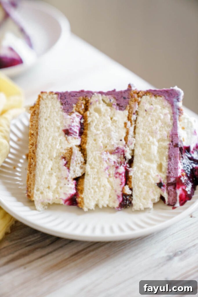 Overhead view of a prepared blueberry cheesecake cake slice with a fork