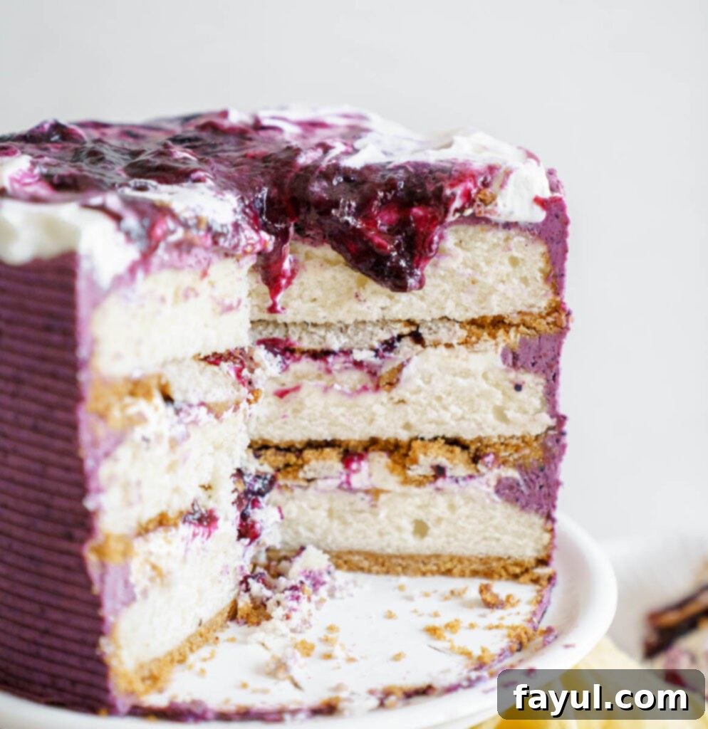 Slice of blueberry cheesecake cake with a fork, ready to be eaten