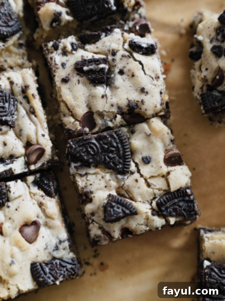 Oreo Blondies, perfectly cut squares showcasing the chewy texture and generous mix-ins of Oreo cookies and chocolate chips.