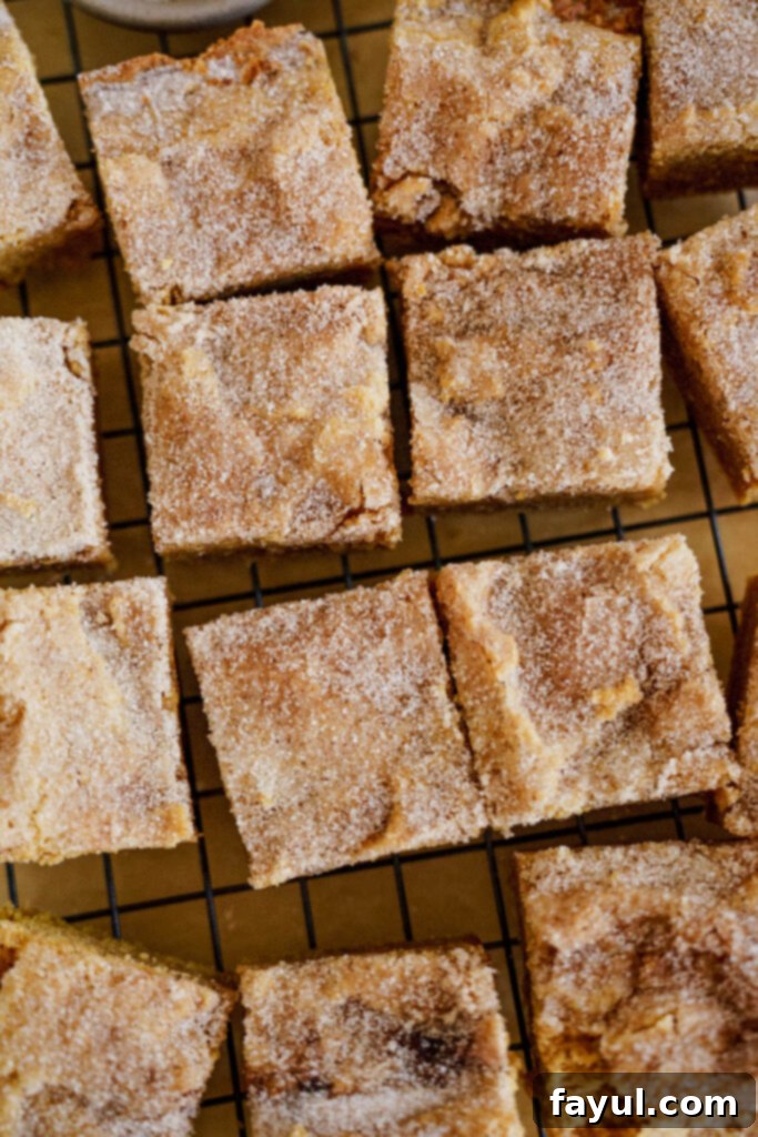 A stack of Pumpkin Snickerdoodle Blondies, showcasing the soft interior and golden crust.