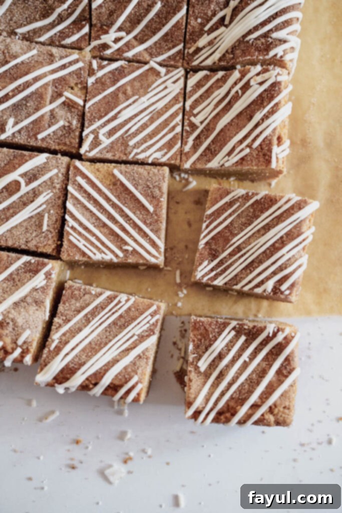 Two Cinnamon Roll Blondies cooling on a wire rack, showing the gooey swirl.