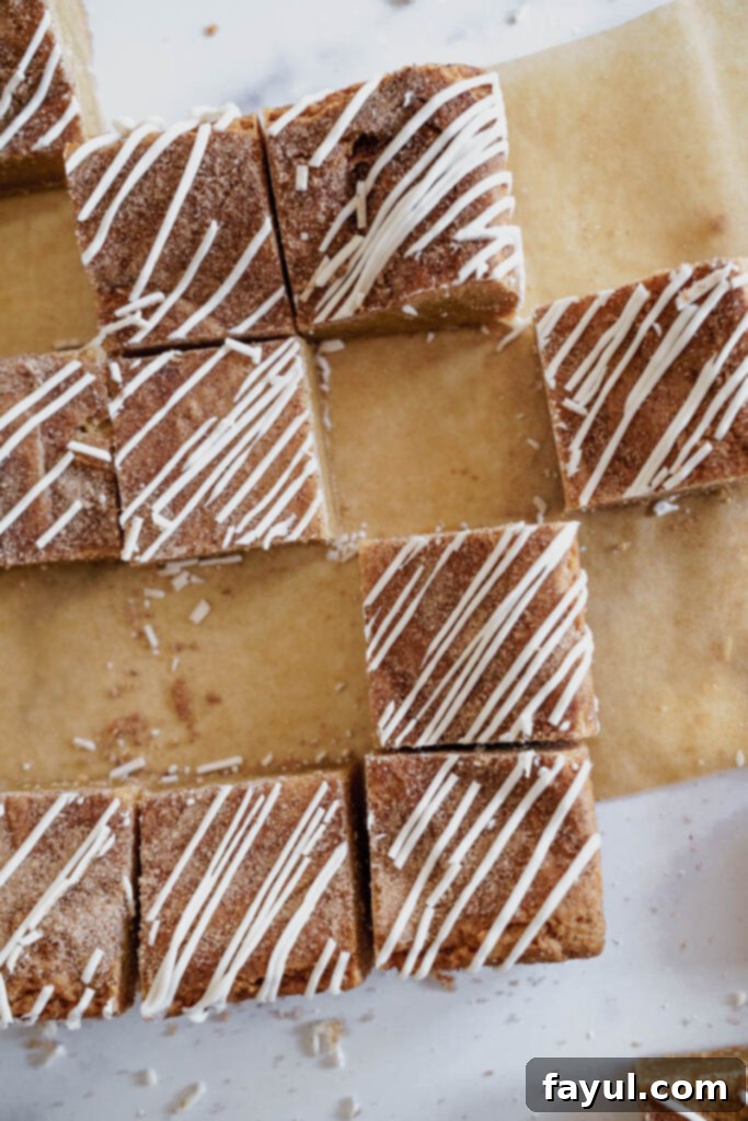 A close-up of a single Cinnamon Roll Blondie square showing the texture and icing.