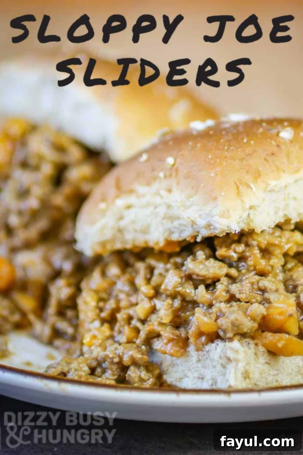 Close up shot of two sloppy joe sliders on a white plate, showcasing the rich, saucy filling on small slider buns.