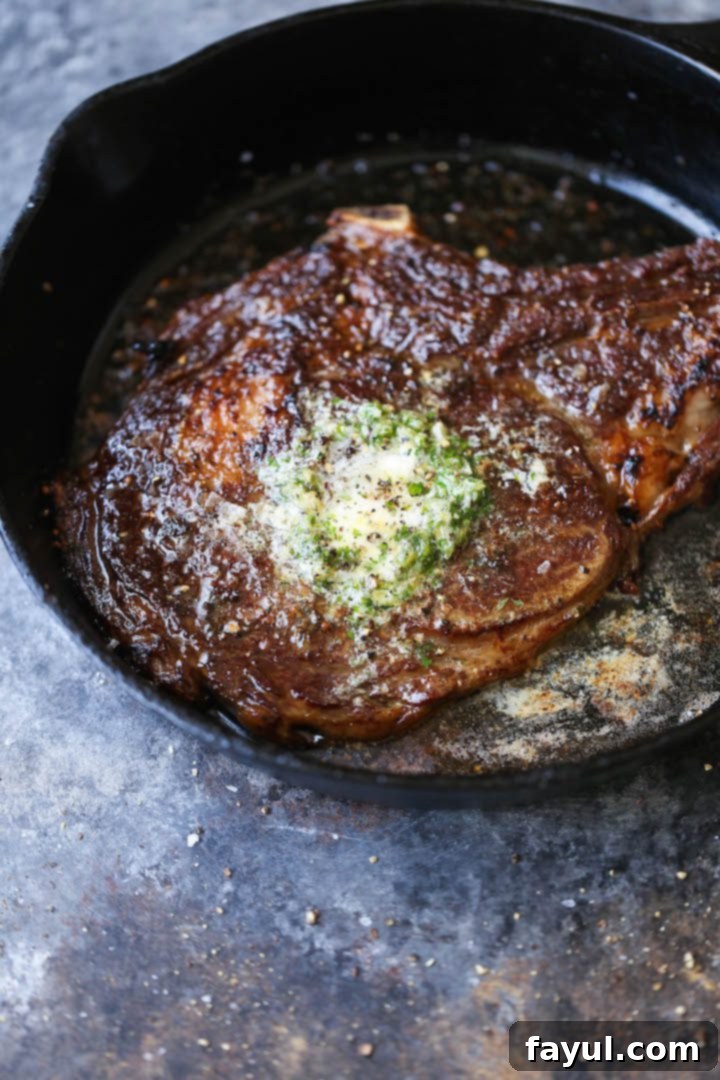 The Perfect Steak with Garlic Butter | Damn Delicious - A succulent steak generously topped with melted garlic butter, highlighting its perfect sear.