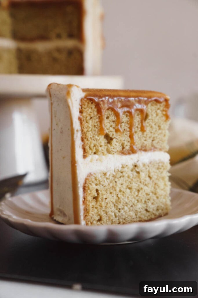Two slices of Chai Caramel Cake on a plate, showing layers of cake, frosting, and caramel