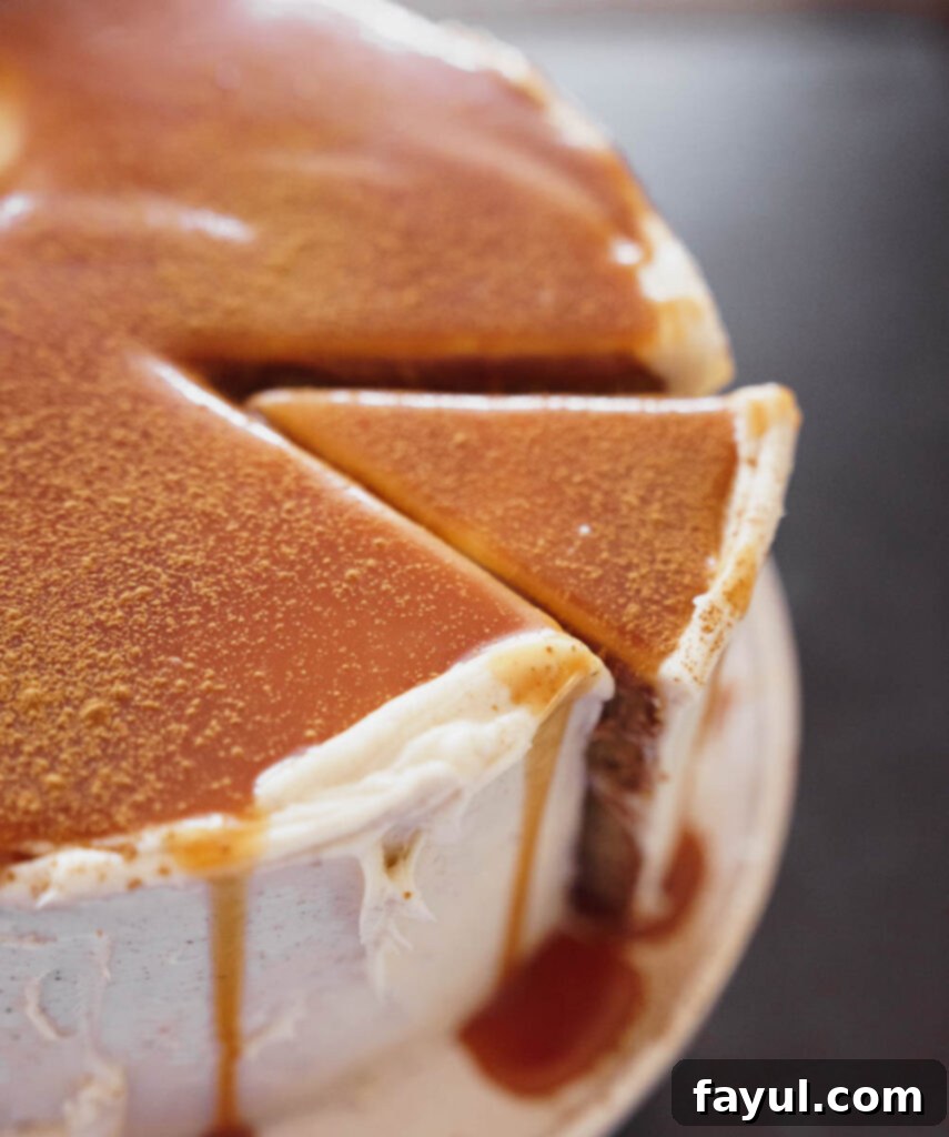 Close-up of the Chai Caramel Cake with thick cream cheese frosting and caramel dripping down