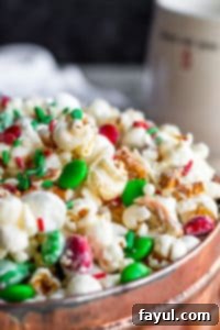 Close up of popcorn snack in a copper tin with a dark blue background.
