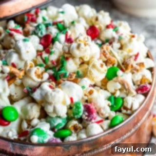 Popcorn snack mix in a copper tin on a white counter.
