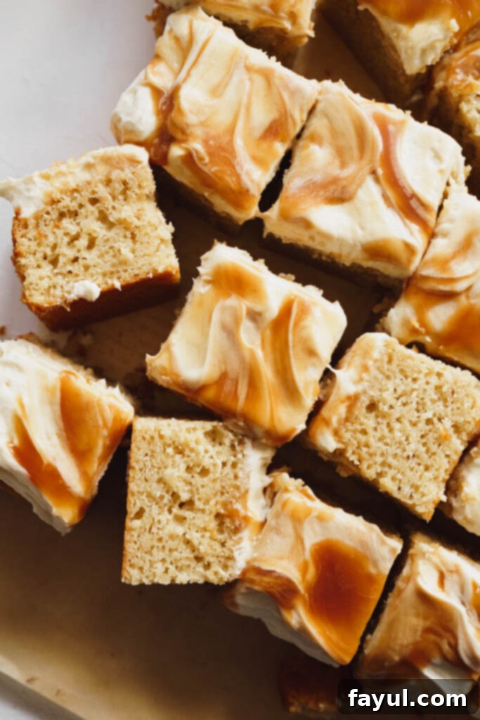 A large slice of Caramel Apple Cake with generous frosting and caramel, ready to be enjoyed