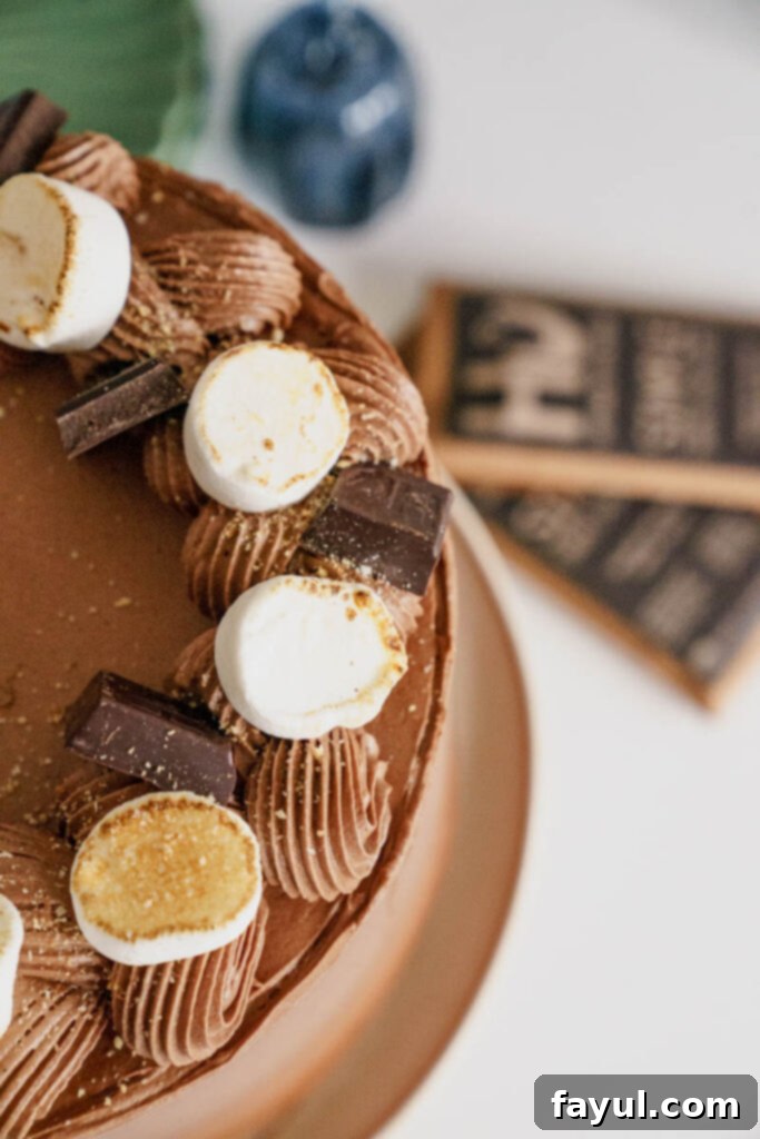 A whole Pumpkin S'mores Cake on a cake stand, ready to be served.