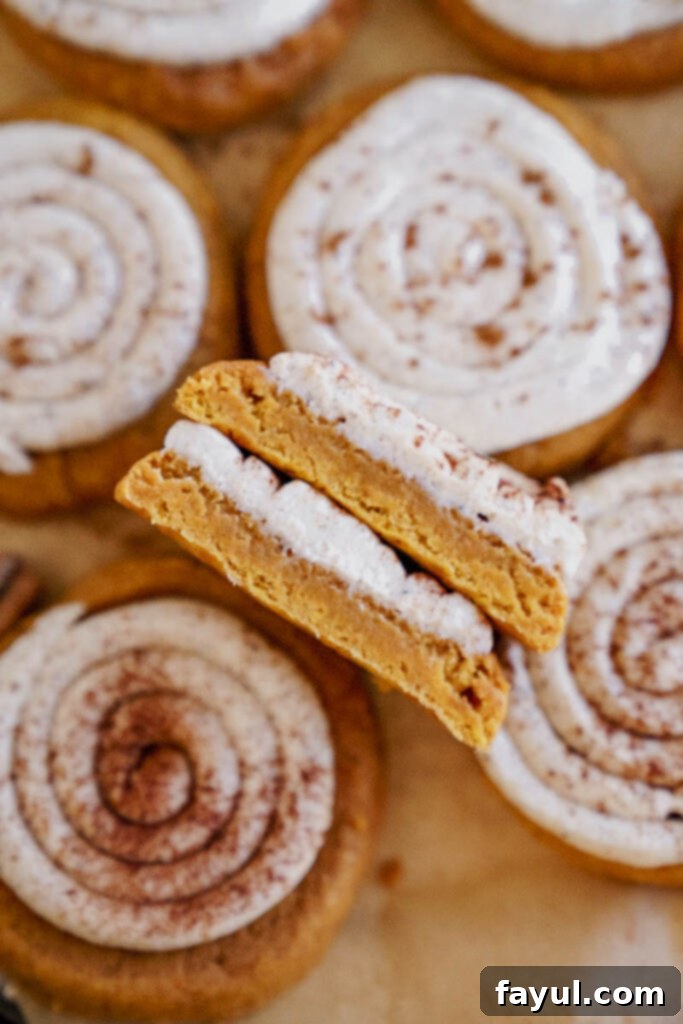 Creamy Pumpkin Spice Sugar Cookie 3 Two Frosted Pumpkin Sugar Cookies on a wooden board