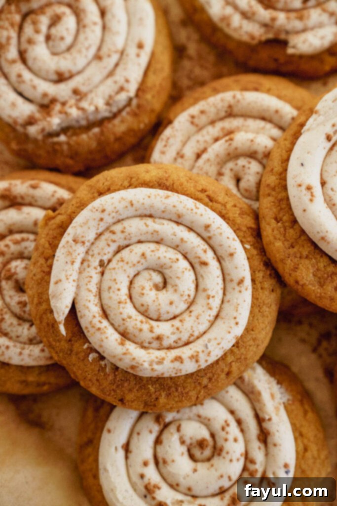 Creamy Pumpkin Spice Sugar Cookie 4 Stack of Frosted Pumpkin Sugar Cookies with a bite taken out