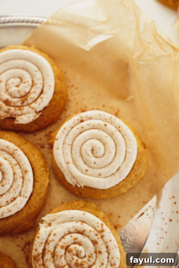 Creamy Pumpkin Spice Sugar Cookie 8 A frosted pumpkin sugar cookie with a thick layer of cream cheese frosting