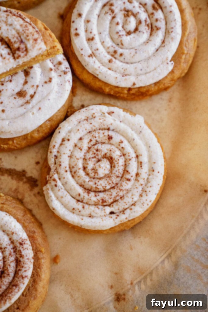 Creamy Pumpkin Spice Sugar Cookie 9 Close-up of frosted pumpkin sugar cookies, dusted with cinnamon