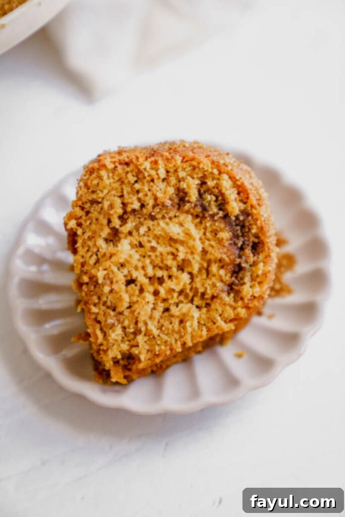 Close-up of a slice of Pumpkin Churro Bundt Cake showing the cinnamon swirl