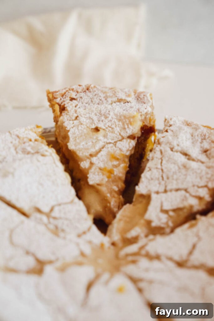 Gooey Butter Pumpkin Cake sliced into squares for serving.