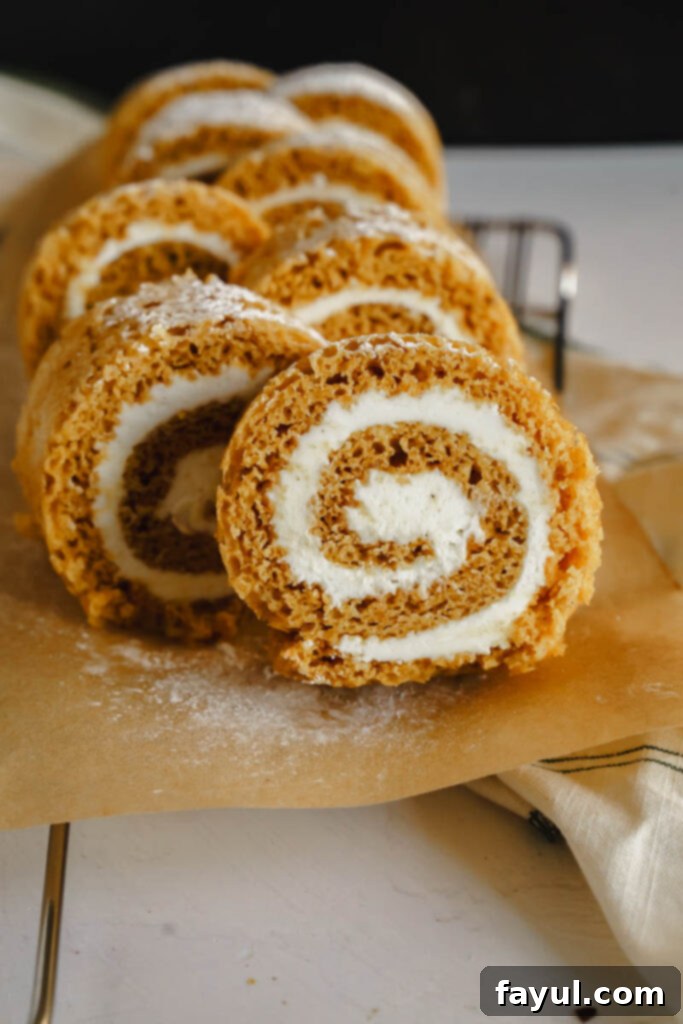 Smiling baker holding a freshly baked Pumpkin Roll