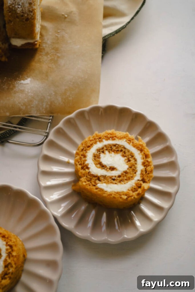 Pumpkin Roll slices arranged on a rustic wooden board
