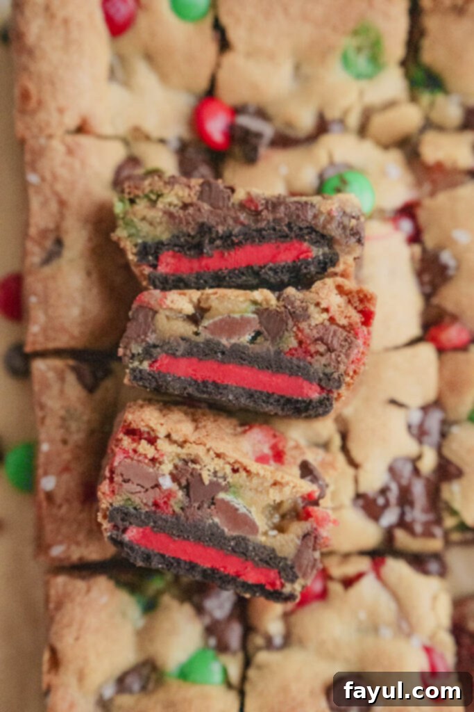 Close-up of a single Oreo M&M Blondie square, showing the Oreo base and chewy top