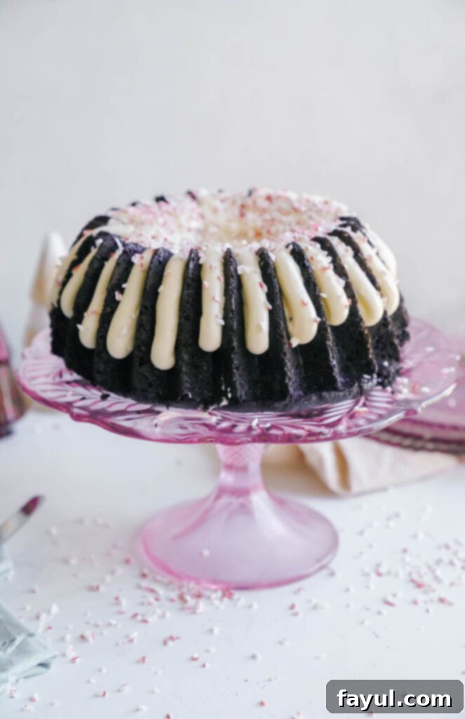 close up of chocolate peppermint bundt cake slice with peppermint pieces