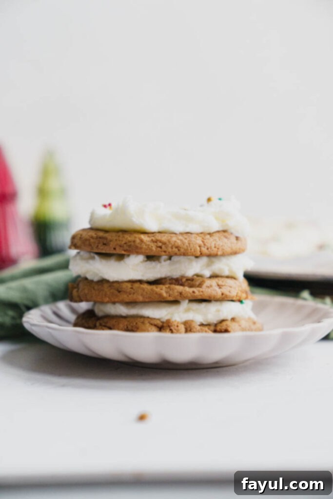 A close-up of a Frosted Gingerbread Cookie with a smooth layer of cream cheese frosting.