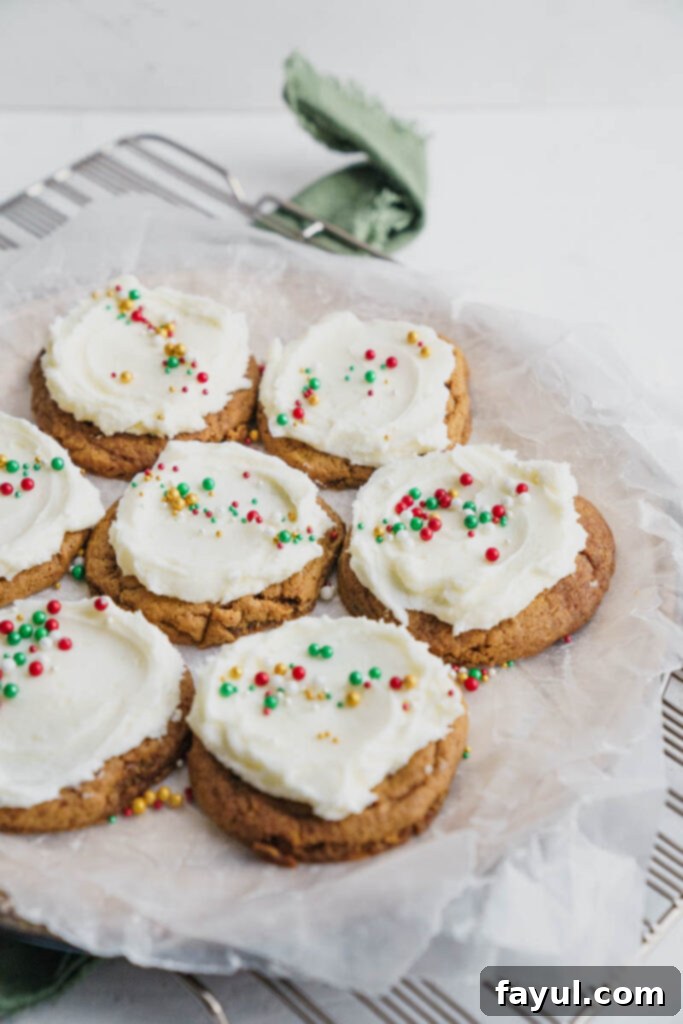 Frosted Gingerbread Cookies on a cooling rack, some with sprinkles.