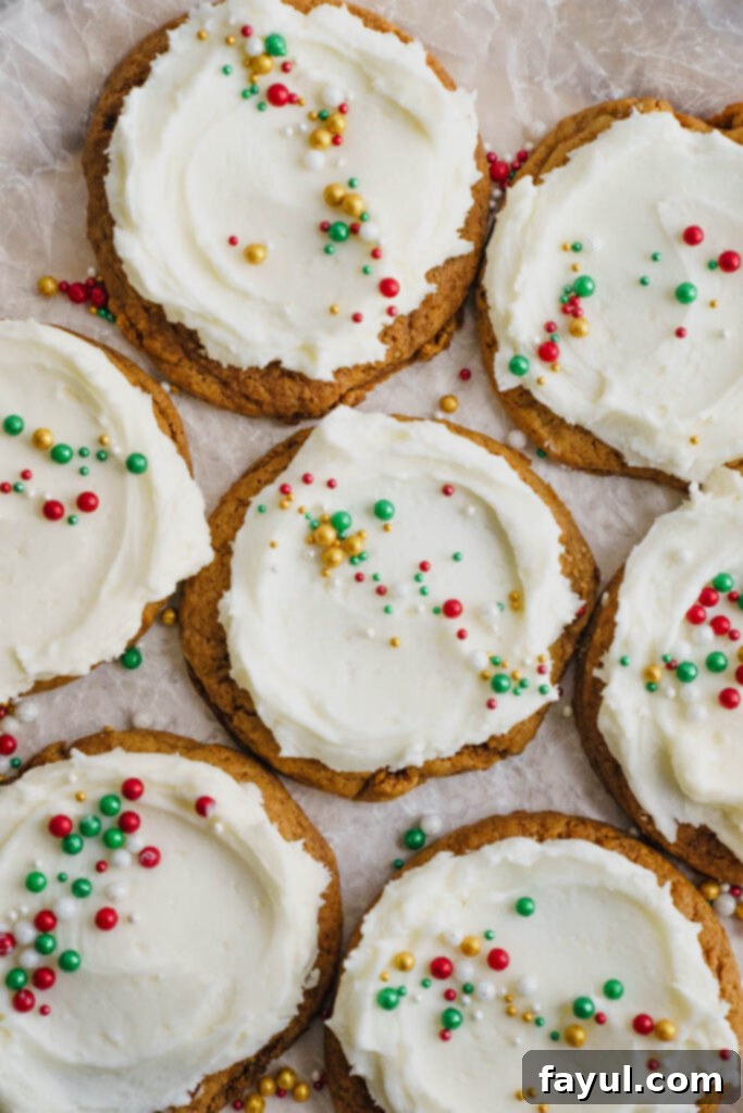 Plate of Frosted Gingerbread Cookies with Christmas sprinkles.